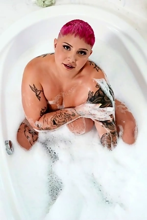 Pink-haired plumper Jadynn Stone sucks and tit fucks firm cock before getting laid